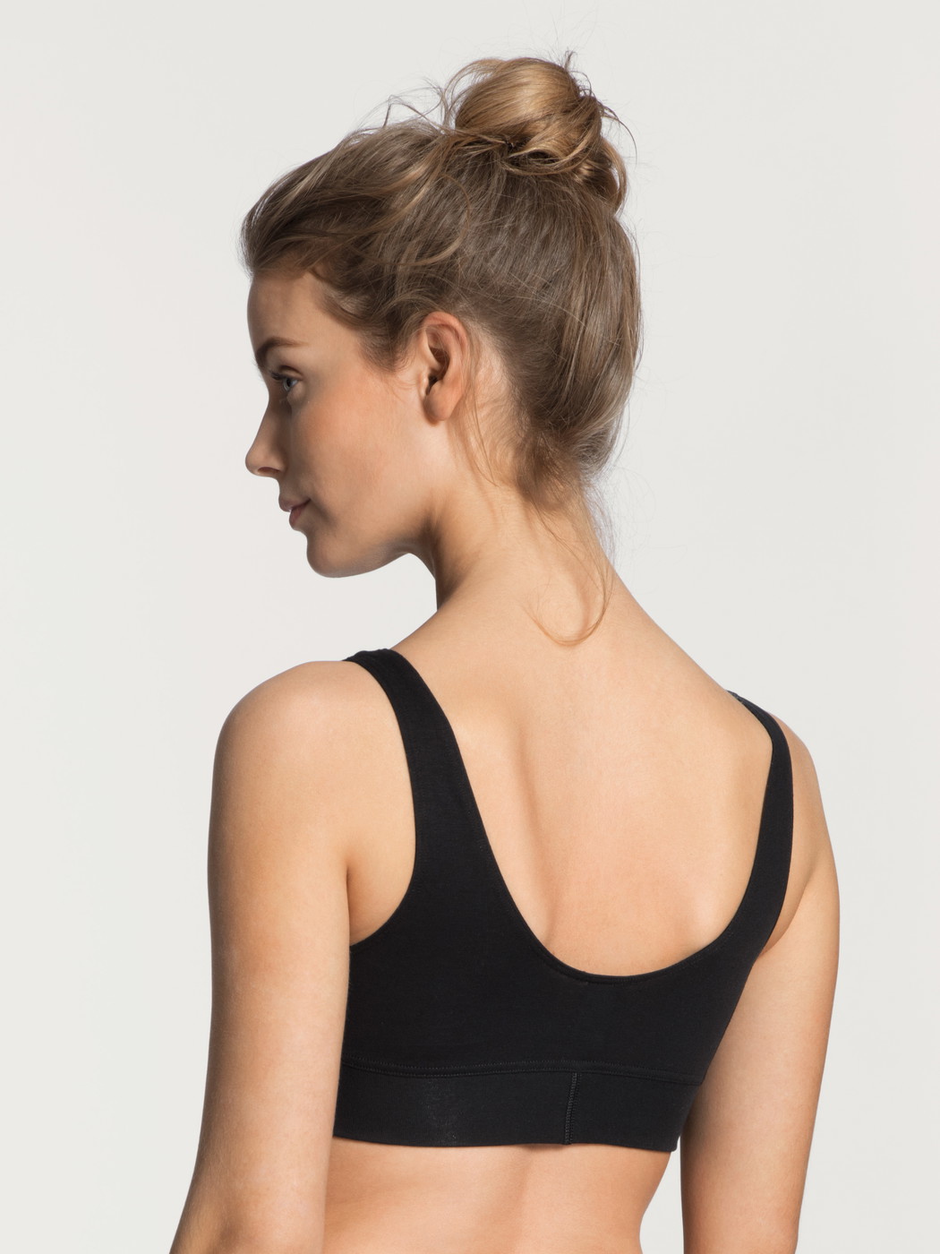Women model is wearing Bustier made of Cotton in Black, Unicoloured from the Elastic series by CALIDA, Back view