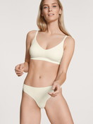 Women model is wearing Bustier with adjustable straps & removable pads made of Modal in White, Unicoloured from the Natural Skin series by CALIDA, Front view, Outfit