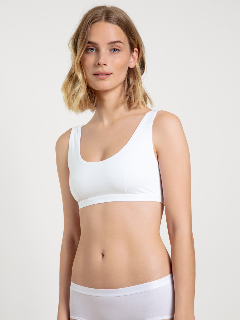 Women model is wearing Bustier, 2-Pack made of Cotton in White, Unicoloured from the Benefit Women series by CALIDA, Front view, Outfit