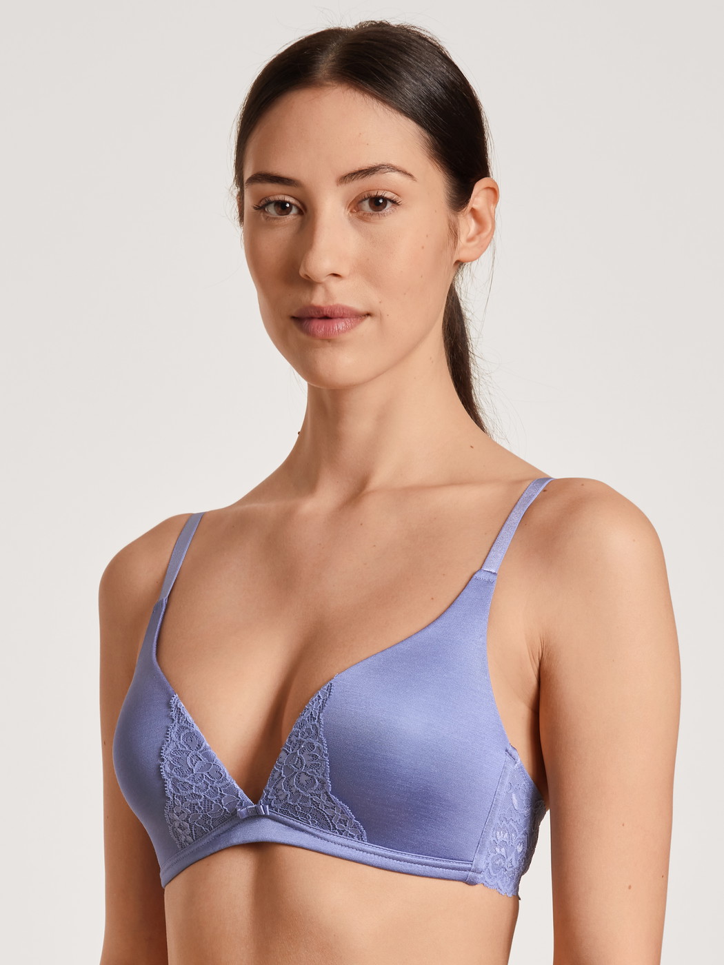 Women model is wearing Triangle bra without underwire made of Cotton in Purple, Lace from the Sensual Secrets series by CALIDA, Front view