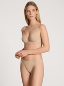 Women model is wearing Spacer bra made of Polyamide in Beige, Lace from the Natural Comfort Lace series by CALIDA, Front view, Outfit