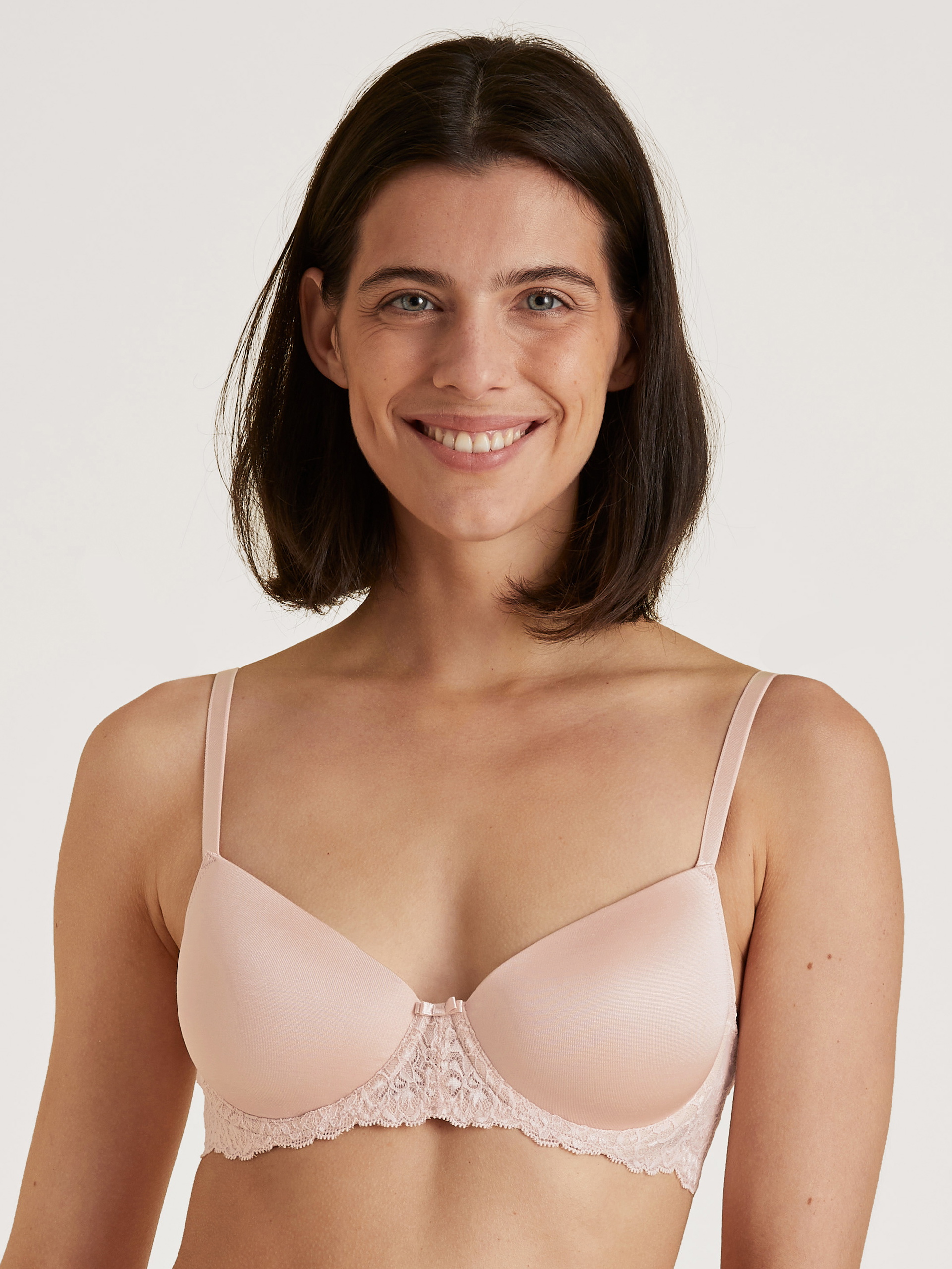 Women model is wearing Underwired T-shirt bra with padding made of Cotton in Pink, Unicoloured from the Sensual Secrets series by CALIDA, Front view