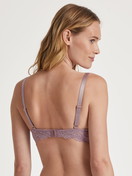 Women model is wearing Spacer bra with wires made of Polyamide in Pink, Lace from the Sensual Secrets series by CALIDA, Back view