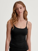 Women model is wearing Spaghetti top made of Cotton in Black, Unicoloured from the Sleek Skin series by CALIDA, Front view