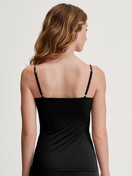 Women model is wearing Spaghetti top made of Cotton in Black, Unicoloured from the Sleek Skin series by CALIDA, Back view