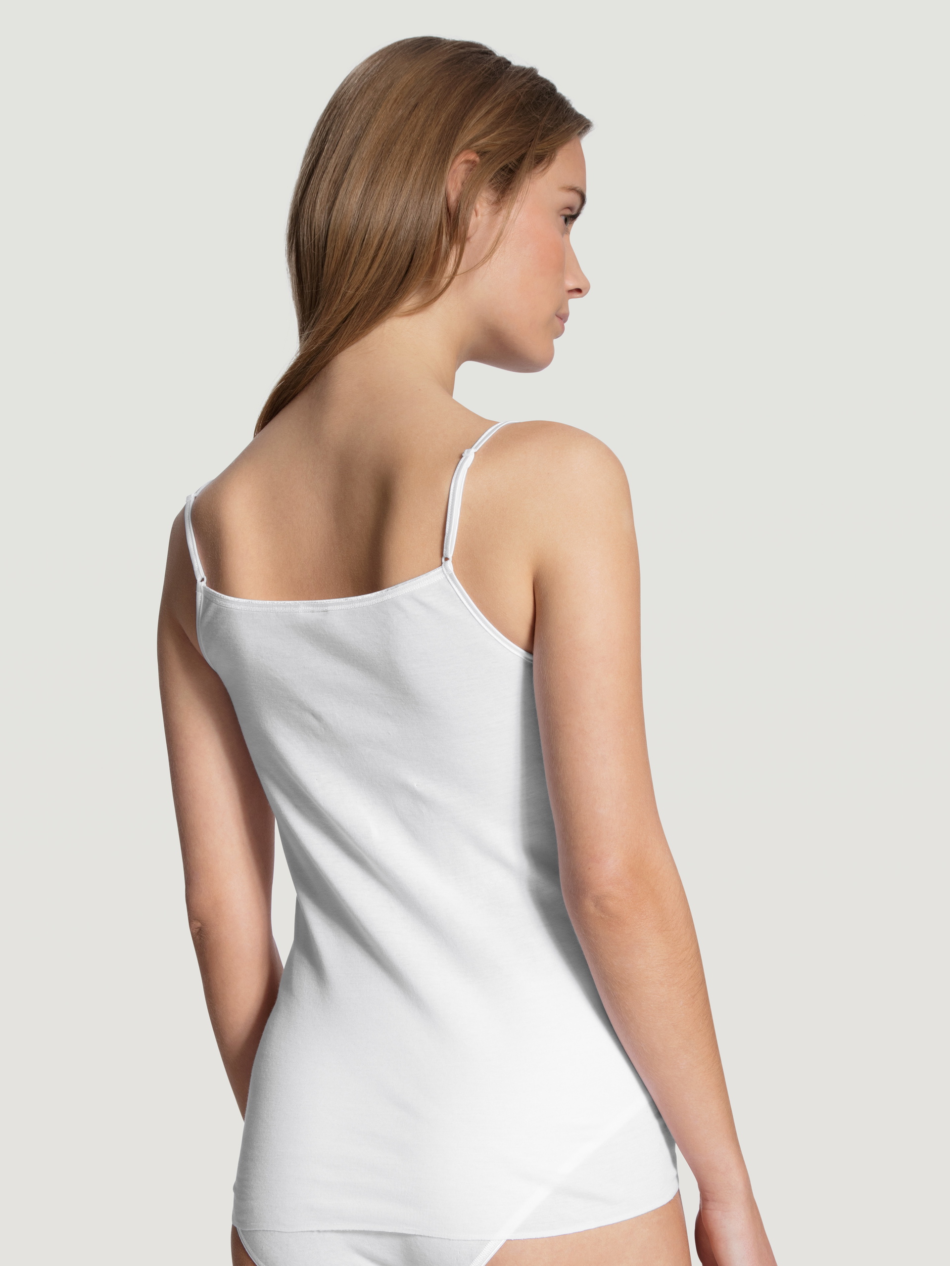 Women model is wearing Spaghetti top made of 100% Cotton in White, Unicoloured from the Feminin Sense series by CALIDA, Back view