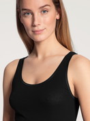 Women model is wearing Tank top made of 100% Cotton in Black, Unicoloured from the Iconics series by CALIDA, Detail, Front view