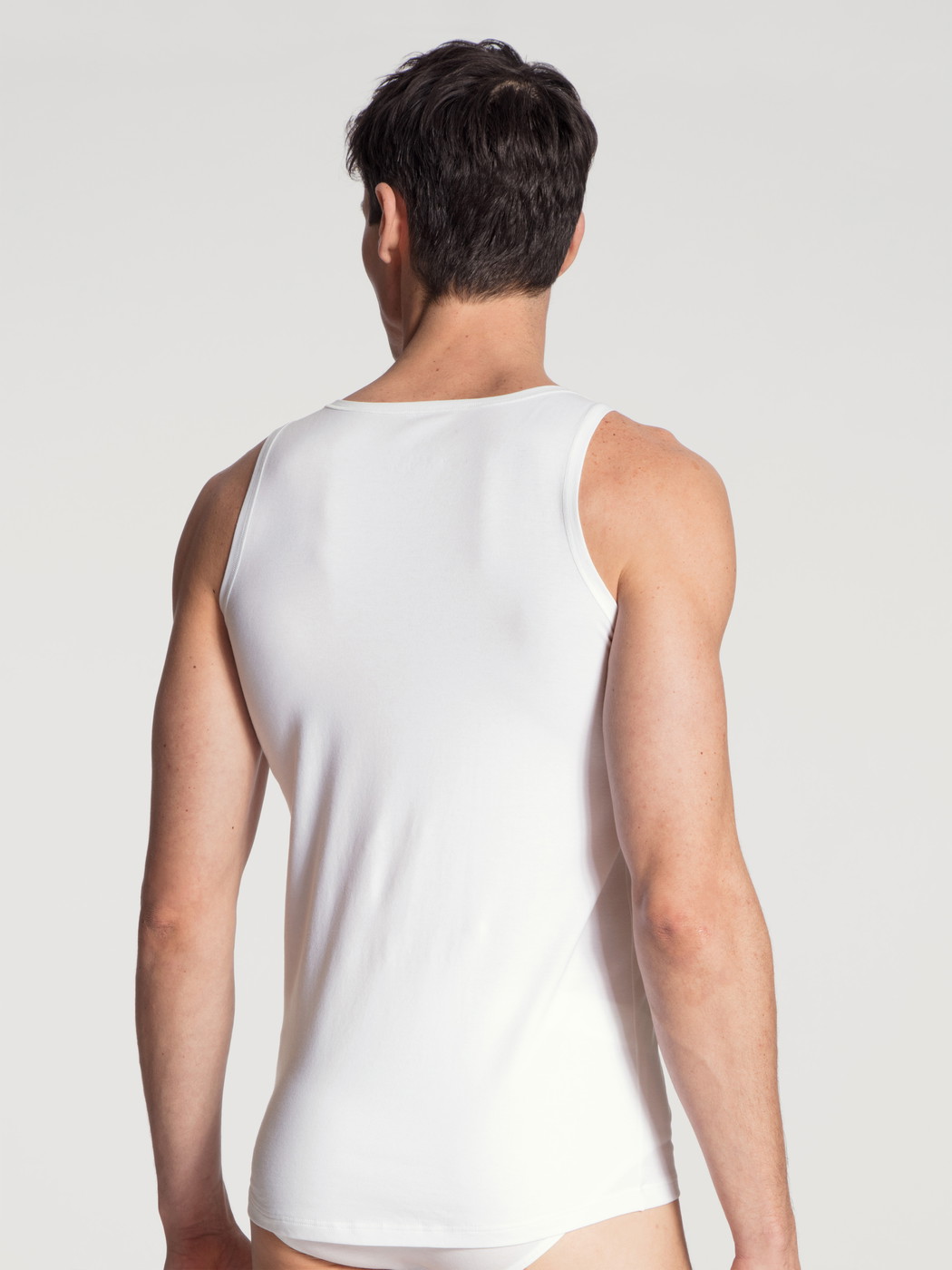Men model is wearing Tank-Top made of Cotton in White, Unicoloured from the Cotton Code series by CALIDA, Back view