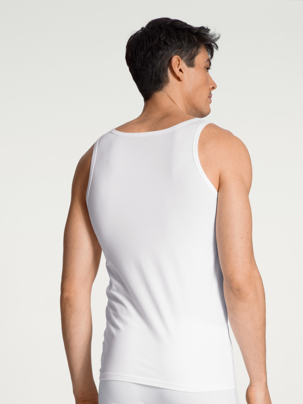 Men model is wearing Tank Top, 2-Pack made of Cotton in White, Unicoloured from the Natural Benefit series by CALIDA, Back view
