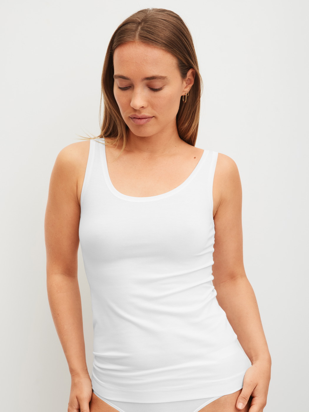 Women model is wearing Tank top made of Modal in White, Unicoloured from the Soft Favourites series by CALIDA, Front view