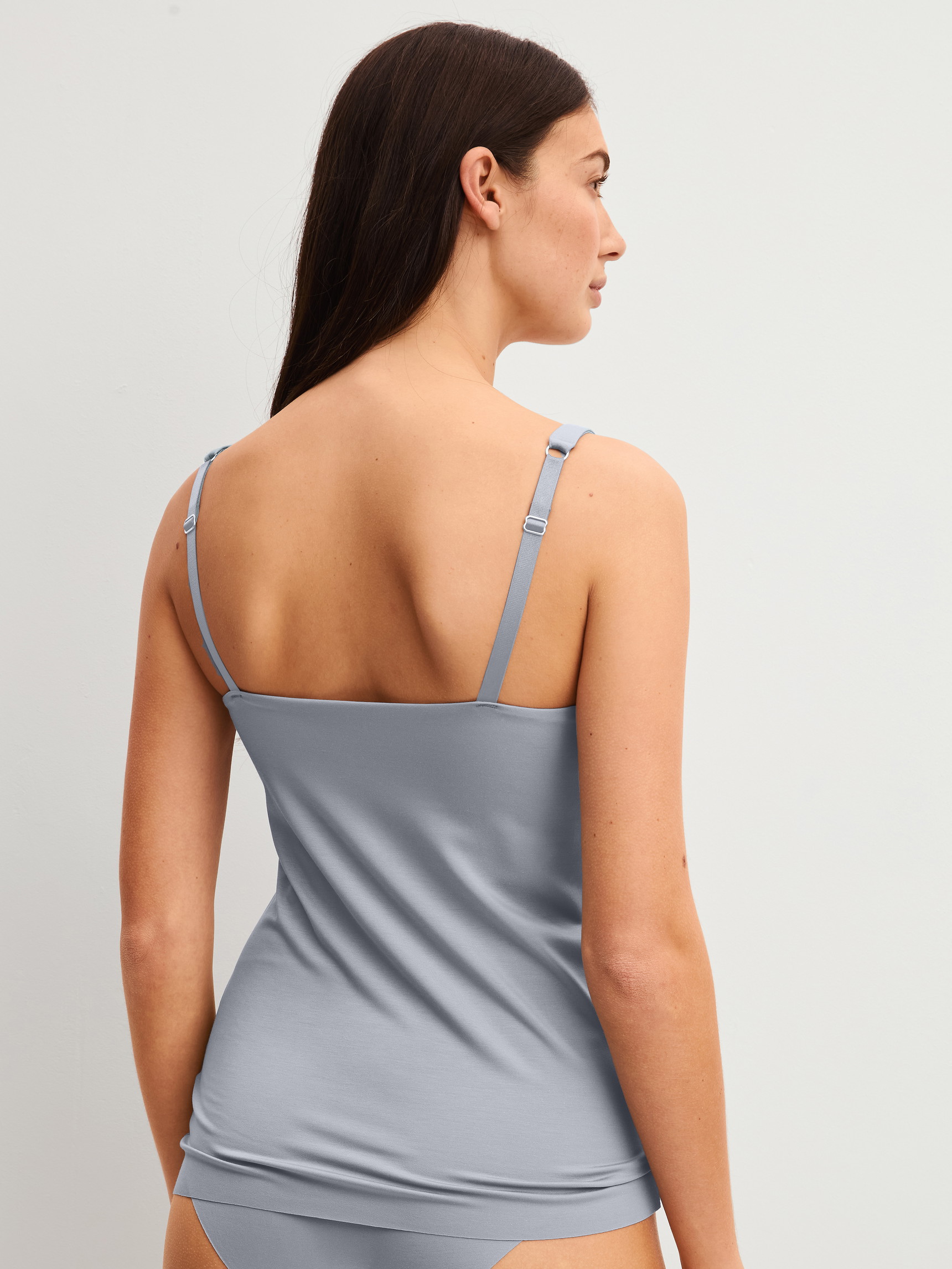 Women model is wearing Tank top with bustier made of Modal in Grey, Unicoloured from the Natural Skin series by CALIDA, Back view