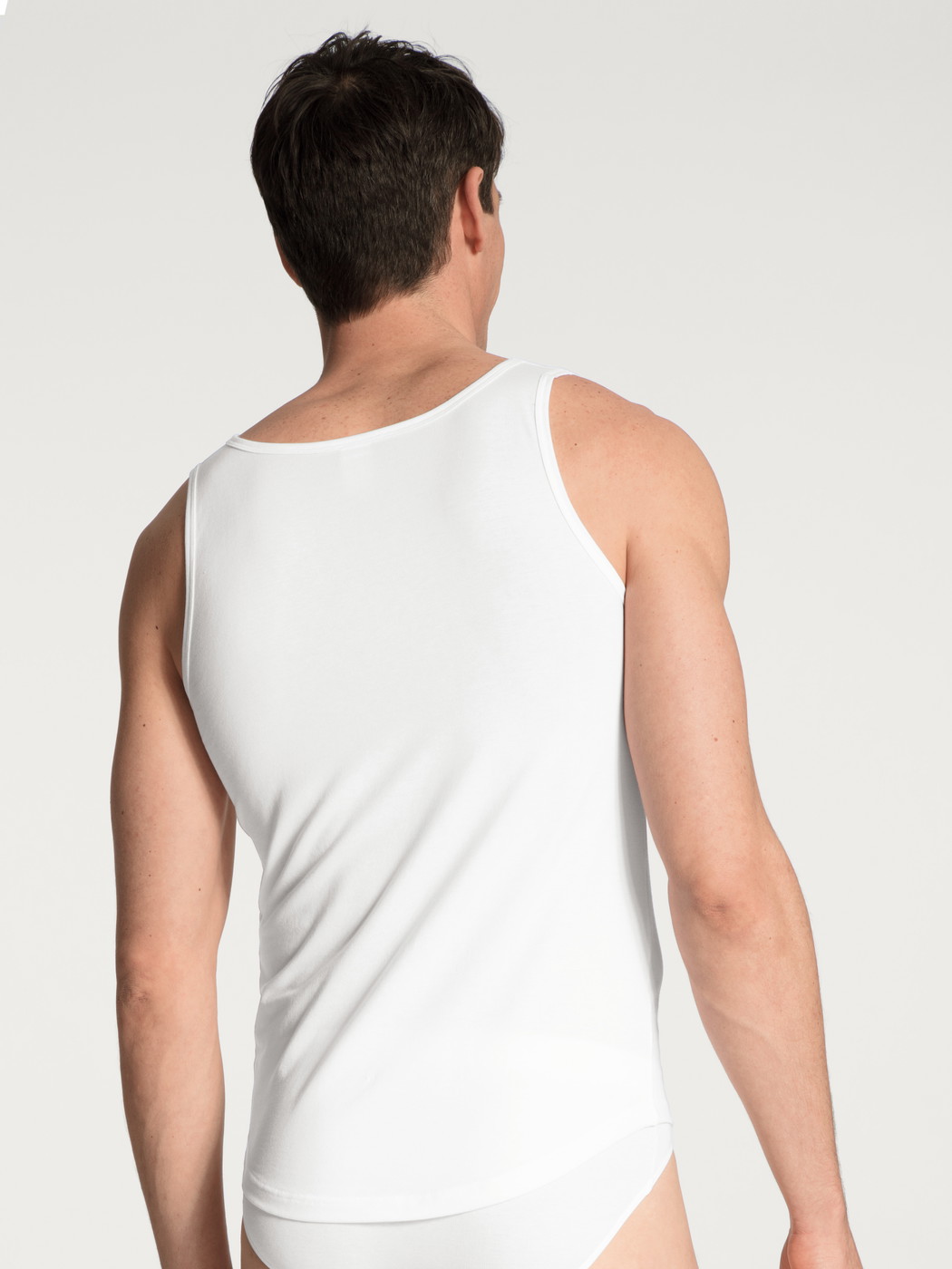 Men model is wearing Tank-Top made of Cotton in White, Unicoloured from the Evolution series by CALIDA, Back view