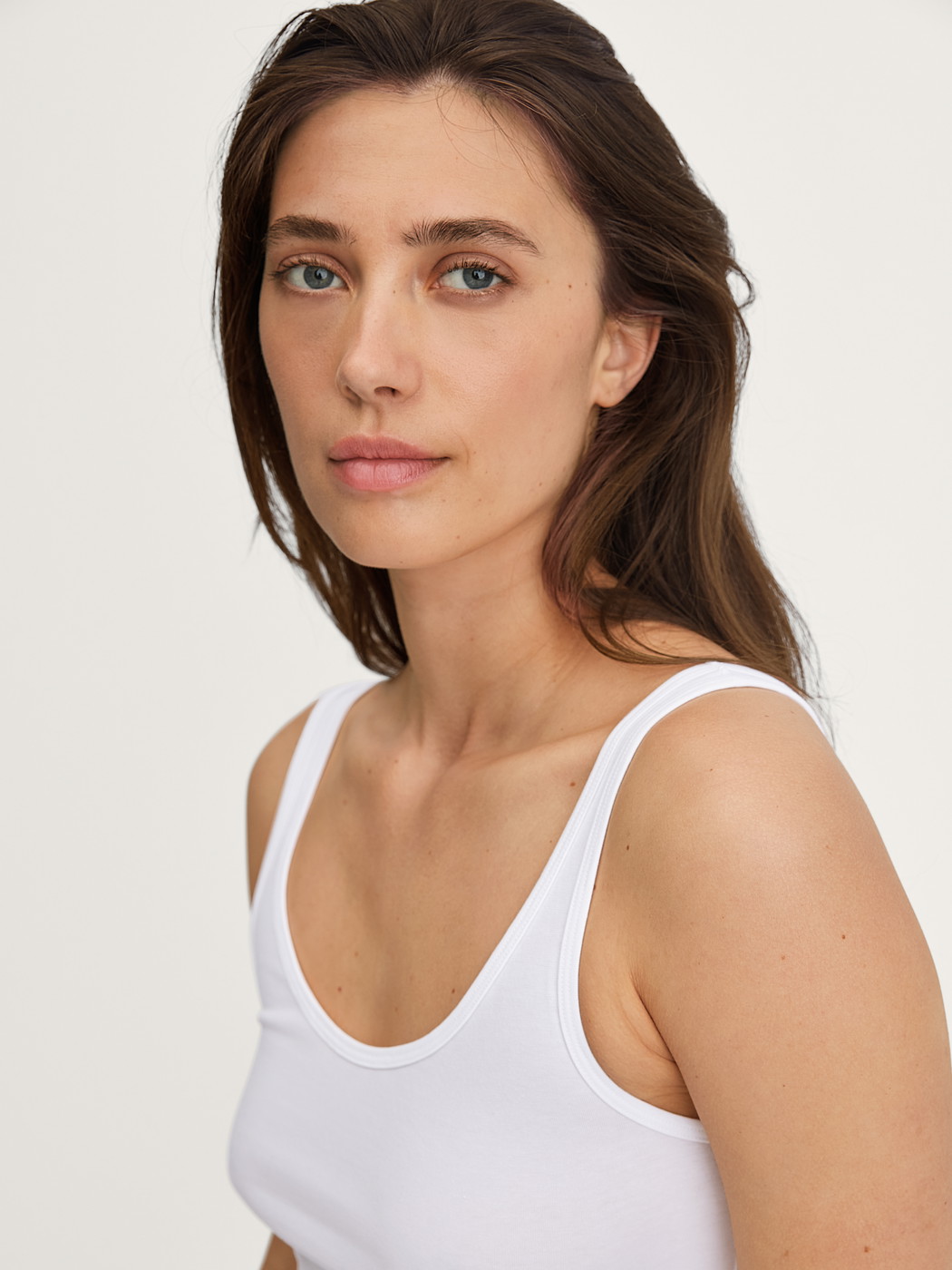 La modella / Il modello Donna indossa Tank top in Cotone di colore Bianco, Tinta unita, della serie Essential Cotton di CALIDA, Dettaglio