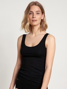 Women model is wearing Tank Top, 2-Pack made of Cotton in Black, Unicoloured from the Benefit Women series by CALIDA, Front view