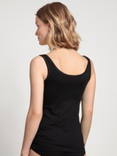 Women model is wearing Tank Top, 2-Pack made of Cotton in Black, Unicoloured from the Benefit Women series by CALIDA, Back view