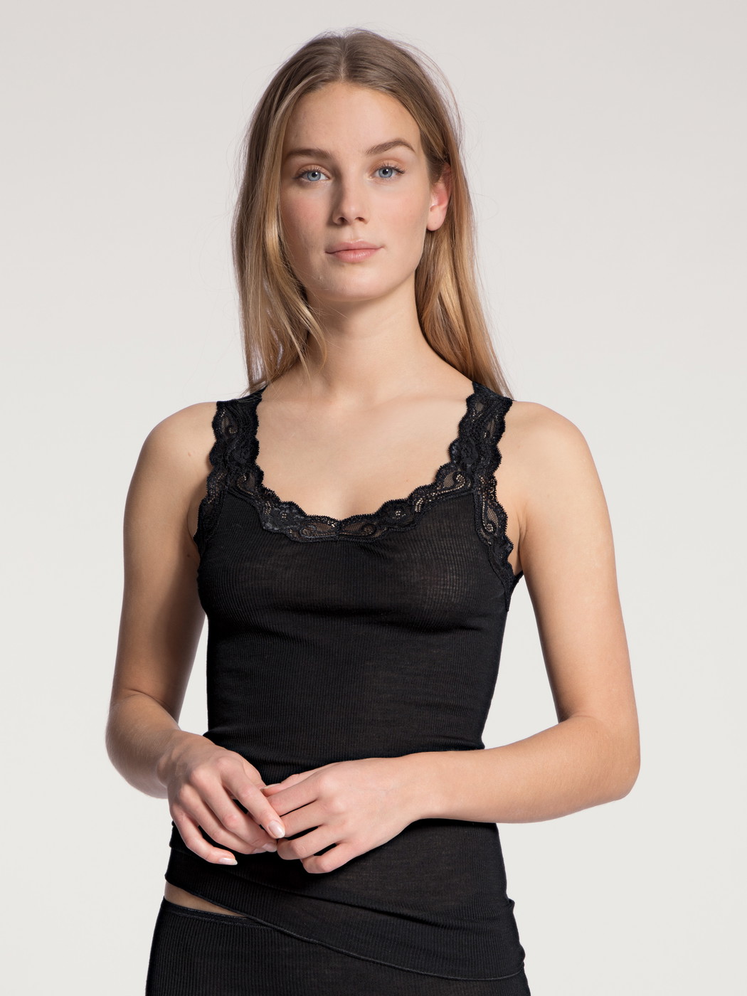 Women model is wearing Tank top made of Wool in Black, Lace from the Richesse Lace series by CALIDA, Front view