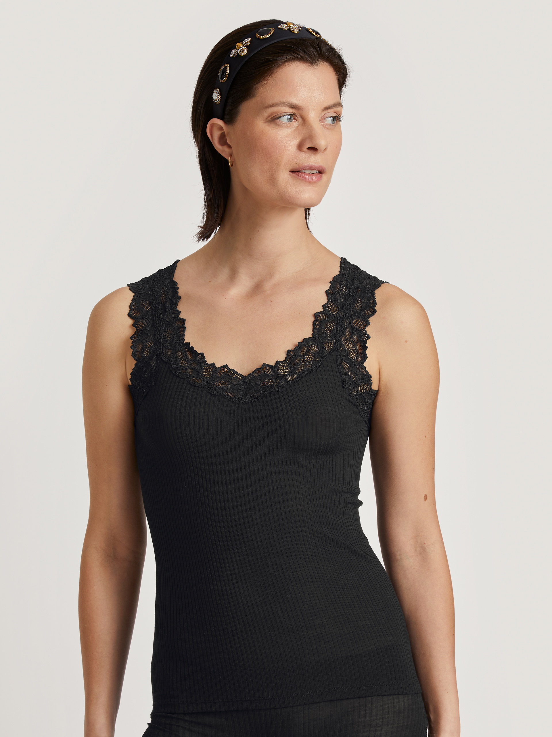 Women model is wearing Tank top made of Wool in Black, Lace from the Silky Wool Joy series by CALIDA, Front view