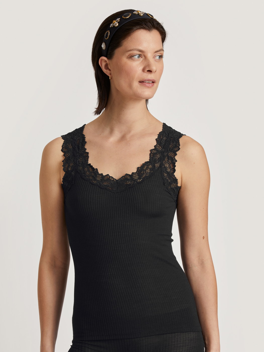 Women model is wearing Tank top made of Wool in Black, Lace from the Silky Wool Joy series by CALIDA, Front view