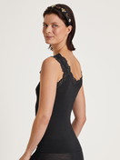 Women model is wearing Tank top made of Wool in Black, Lace from the Silky Wool Joy series by CALIDA, Back view