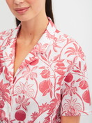 Women model is wearing Short-sleeved shirt with buttons made of 100% Cotton in Orange, Floral from the Favourites Beach series by CALIDA, Detail