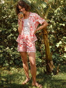 Women model is wearing Short-sleeved shirt with buttons made of 100% Cotton in Orange, Floral from the Favourites Beach series by CALIDA, Additional Image