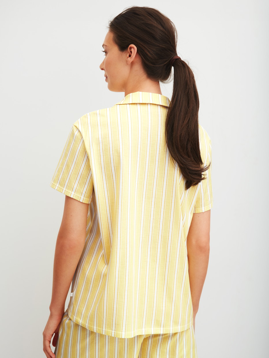 Damen-Model trägt Kurzarm-Shirt mit Knöpfen aus 100% Baumwolle in Gelb, Gestreift aus Serie Favourites Ocean von CALIDA, Rückansicht