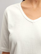 Le mannequin Femme porte le/la T-shirt à manches courtes et col en V en 100% coton de couleur Blanc, Unicolore, de la série Late Bloom M&M de CALIDA, Détail