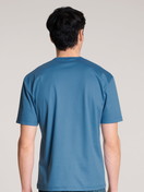 Men model is wearing Short-sleeve shirt made of 100% Cotton in Blue, Unicoloured from the Remix Xtra series by CALIDA, Back view