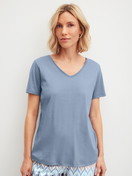 Women model is wearing Short-sleeved shirt made of 100% Cotton in Blue, Unicoloured from the Favourites Tiles series by CALIDA, Front view