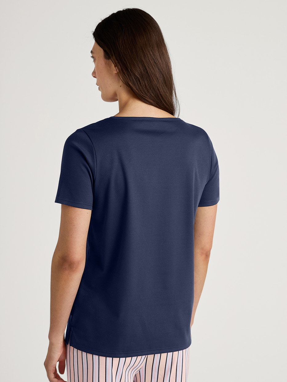 Women model is wearing Short-sleeved shirt made of 100% Cotton in Blue, Unicoloured from the Favourites Sleep series by CALIDA, Back view