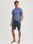Men model is wearing Short-sleeved shirt made of 100% Cotton in Blue, Unicoloured from the Remix Basic Sleep series by CALIDA, Outfit