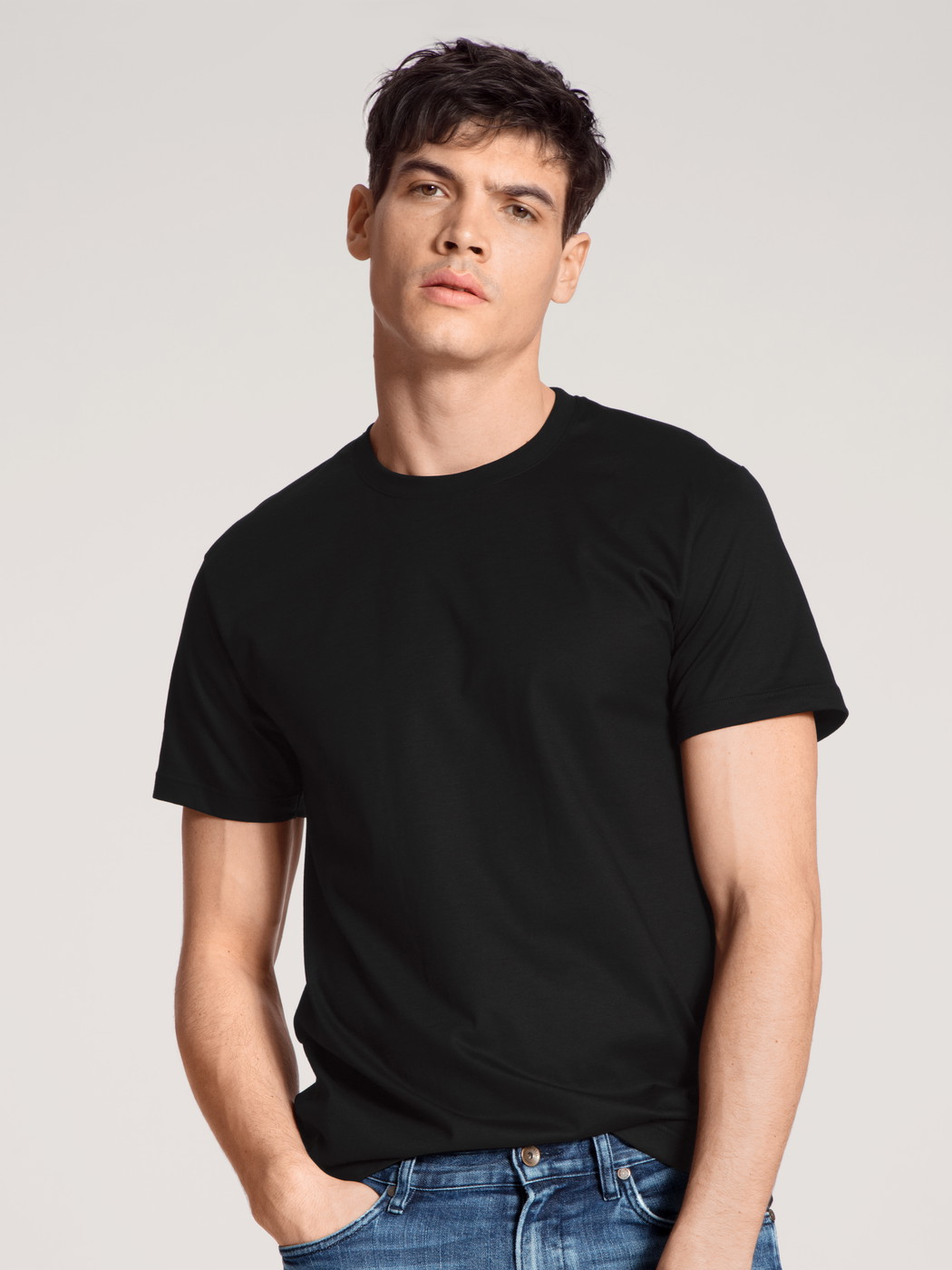 La modella / Il modello Uomo indossa T-Shirt, 2er-Pack in 100% cotone di colore Nero, Tinta unita, della serie Natural Benefit di CALIDA, Vista frontale