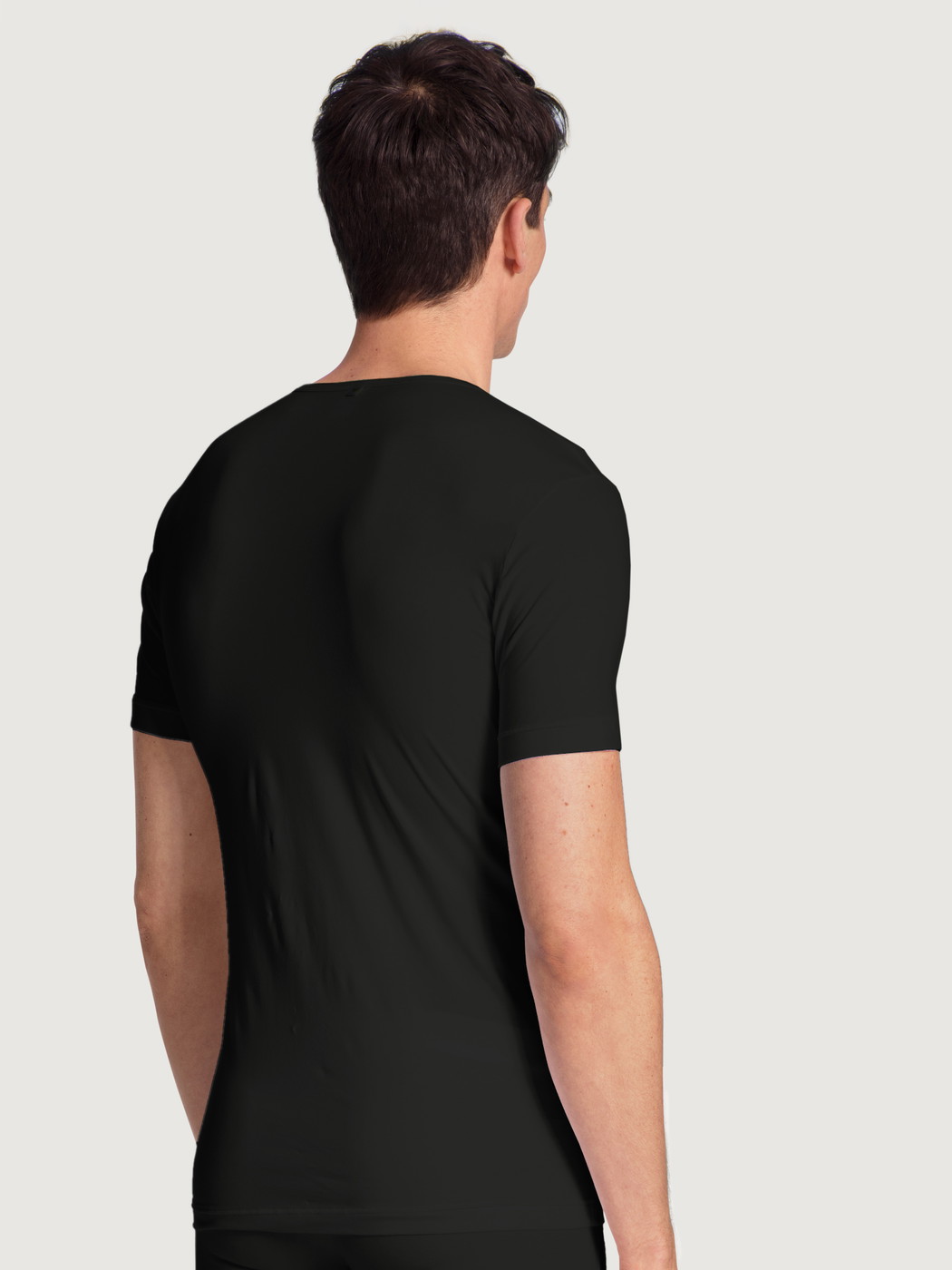 Men model is wearing T-Shirt made of Lyocell in Black, Unicoloured from the Focus series by CALIDA, Back view