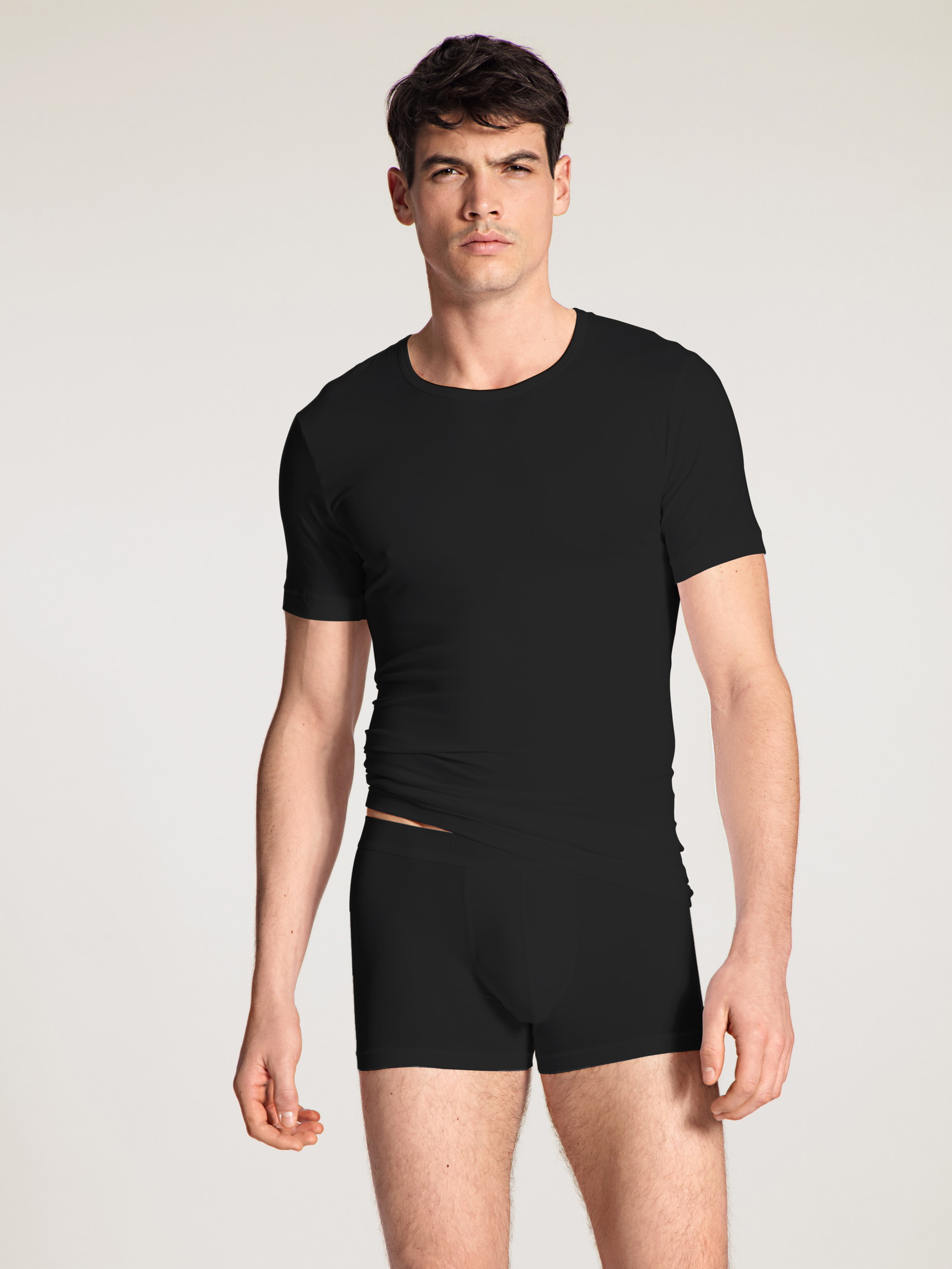 Men model is wearing T-Shirt made of Lyocell in Black, Unicoloured from the Focus series by CALIDA, Outfit