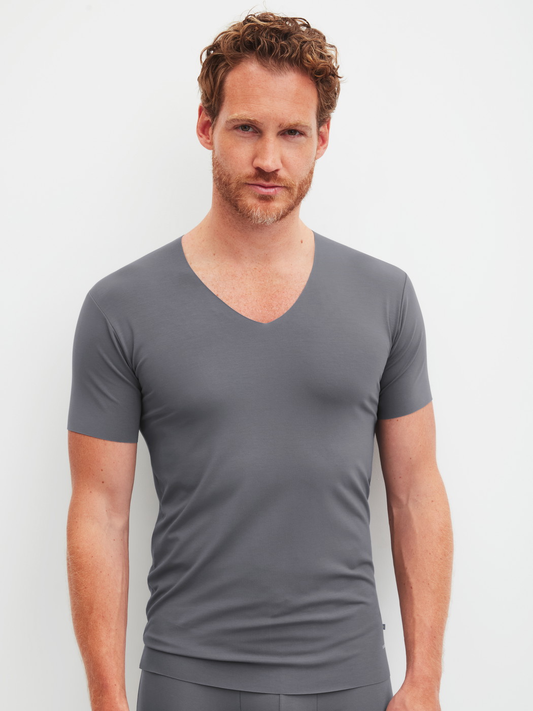Men model is wearing V-shirt made of Modal in Grey, Unicoloured from the Clean Line series by CALIDA, Front view