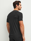 Men model is wearing V-shirt made of Modal in Black, Unicoloured from the Clean Line series by CALIDA, Back view