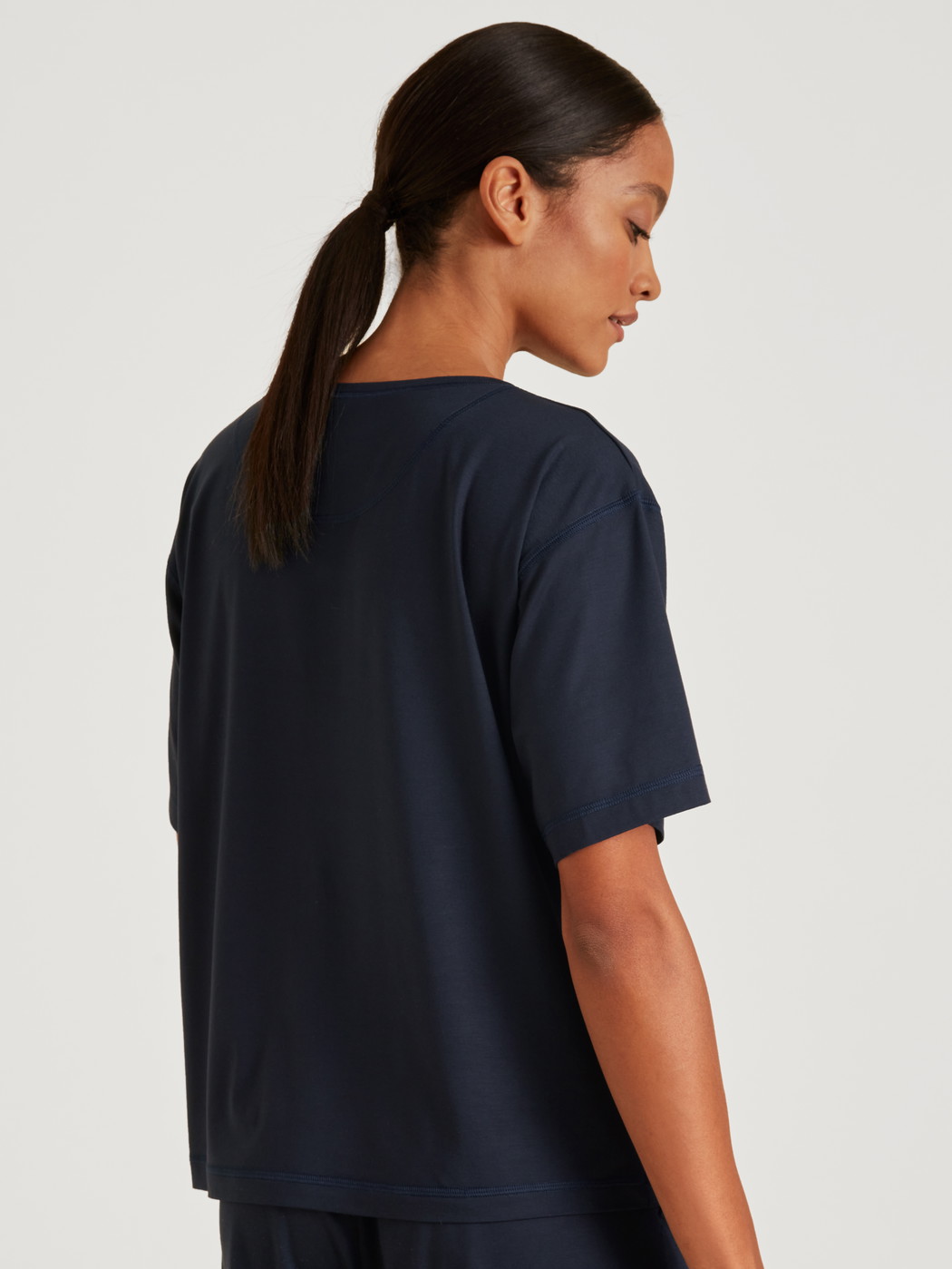 Women model is wearing Shirt short sleeve made of Modal in Blue, Unicoloured from the DSW Balancing series by CALIDA, Back view