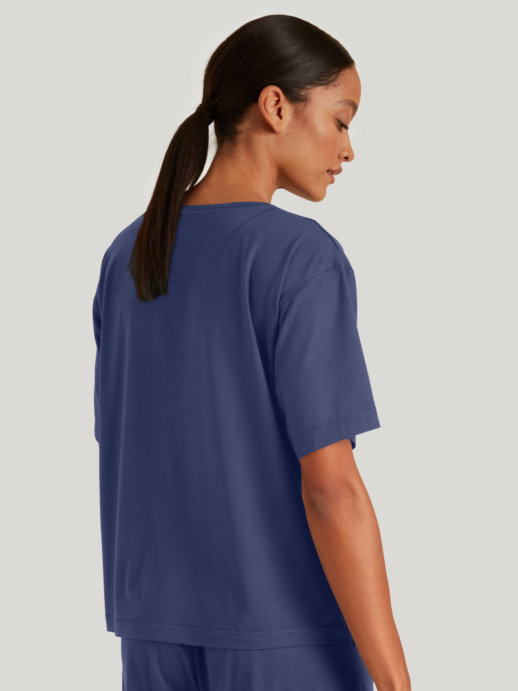 Women model is wearing Shirt short sleeve made of Modal in Blue, Unicoloured from the DSW Balancing series by CALIDA, Back view