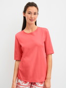 Women model is wearing Short-sleeved shirt made of 100% Cotton in Orange, Unicoloured from the Favourites Beach series by CALIDA, Front view