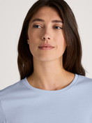 Women model is wearing Short-sleeved shirt made of 100% Cotton in Blue, Unicoloured from the Favourites Sleep series by CALIDA, Detail