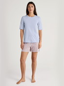 Women model is wearing Short-sleeved shirt made of 100% Cotton in Blue, Unicoloured from the Favourites Sleep series by CALIDA, Additional Image