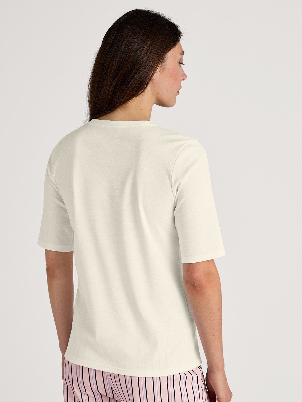 Women model is wearing Short-sleeved shirt made of 100% Cotton in White, Unicoloured from the Favourites Sleep series by CALIDA, Back view