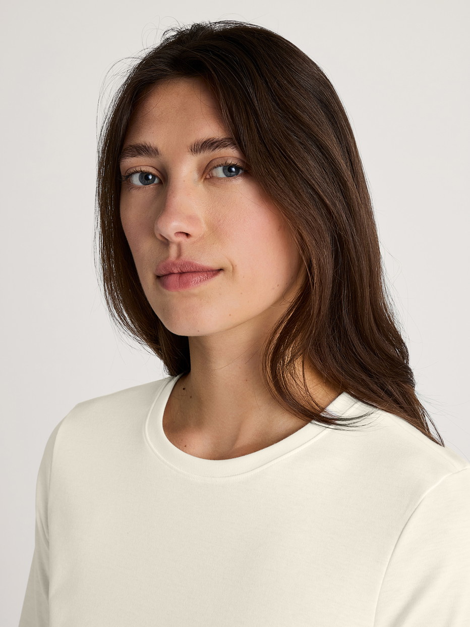 Women model is wearing Short-sleeved shirt made of 100% Cotton in White, Unicoloured from the Favourites Sleep series by CALIDA, Detail