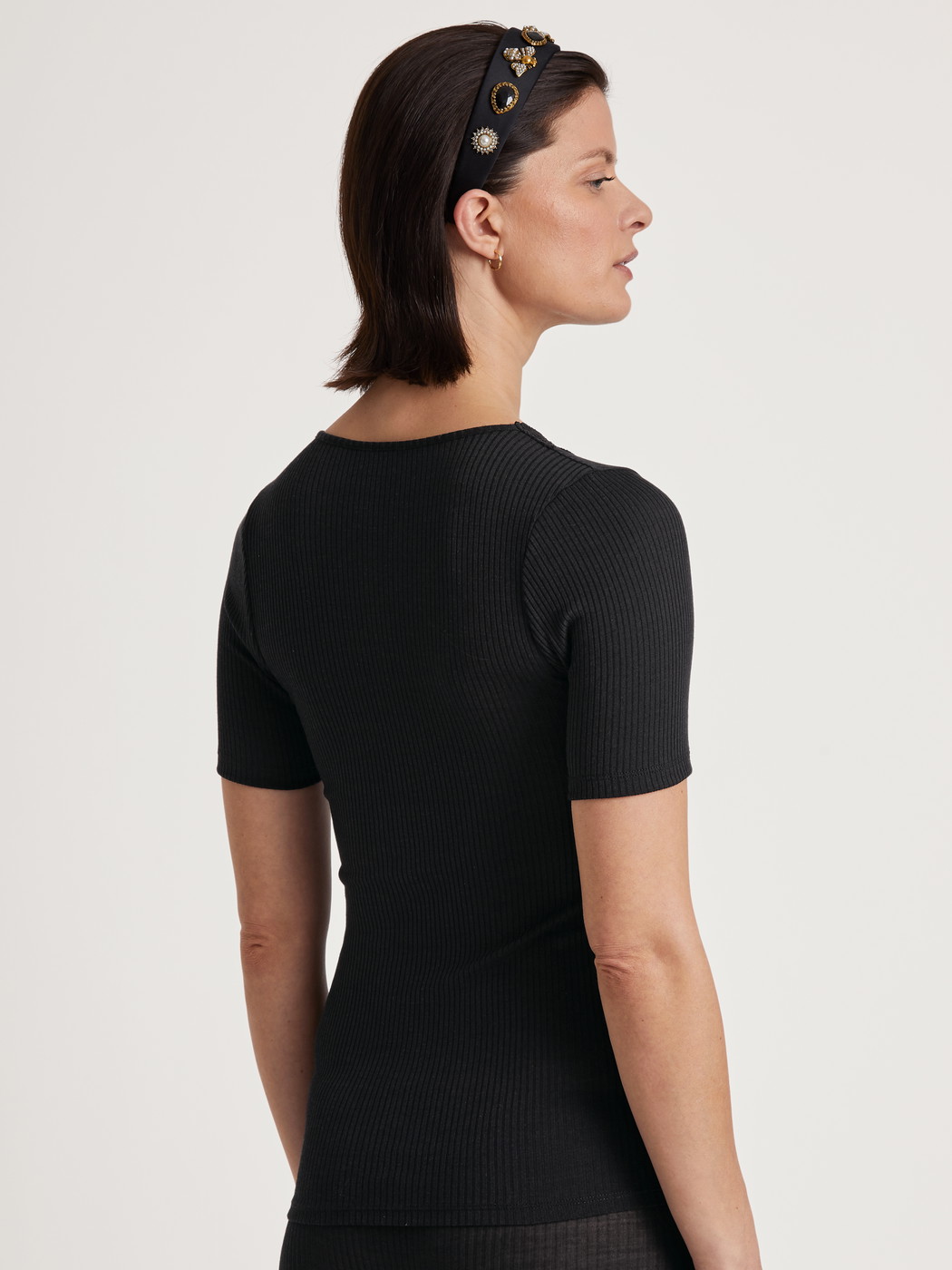 Women model is wearing Shirt short sleeve made of Wool in Black, Lace from the Silky Wool Joy series by CALIDA, Back view