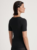 Women model is wearing Shirt short sleeve made of Wool in Black, Lace from the Silky Wool Joy series by CALIDA, Back view