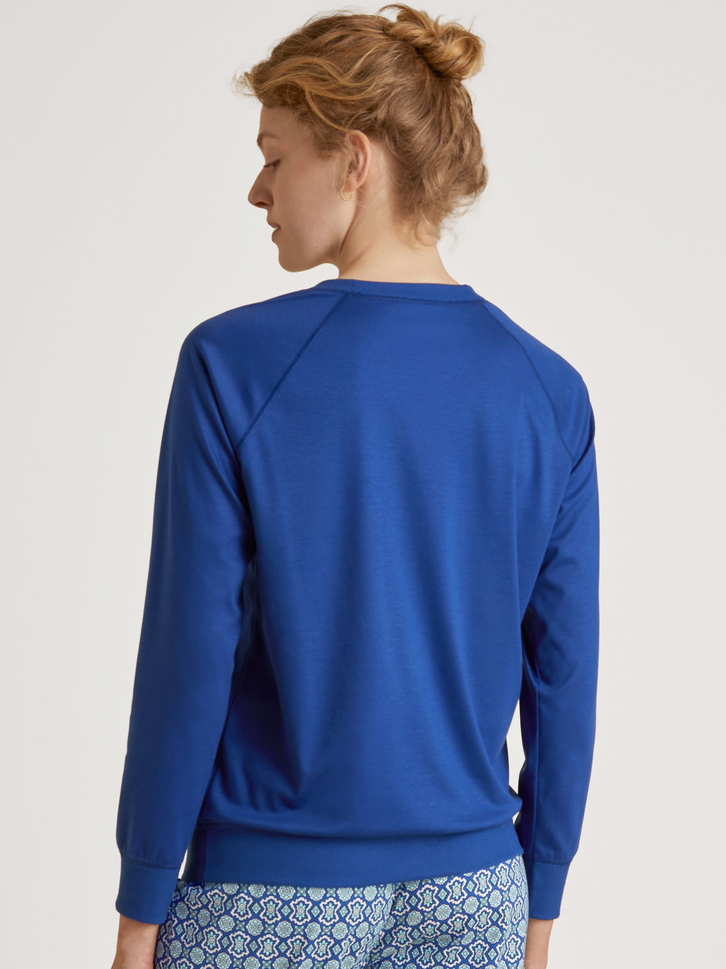 Women model is wearing Shirt long sleeve made of 100% Cotton in Blue, Unicoloured from the Favourites Energy series by CALIDA, Back view