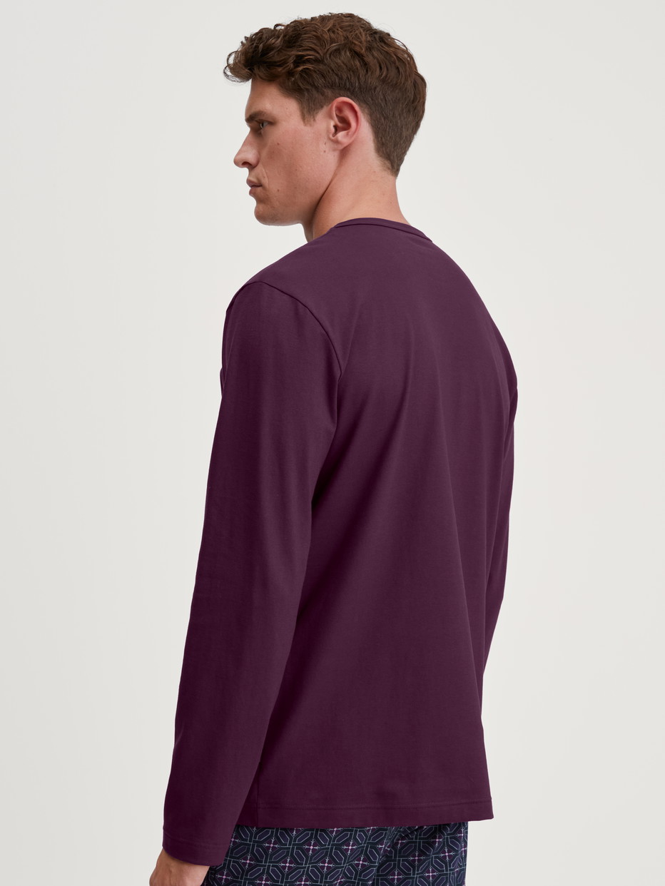 Men model is wearing Shirt long sleeve made of 100% Cotton in Red, Unicoloured from the RMX Sleep Holiday series by CALIDA, Back view