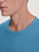 Men model is wearing Shirt long sleeve made of 100% Cotton in Blue, Unicoloured from the RMX Sleep Leisure series by CALIDA, Detail
