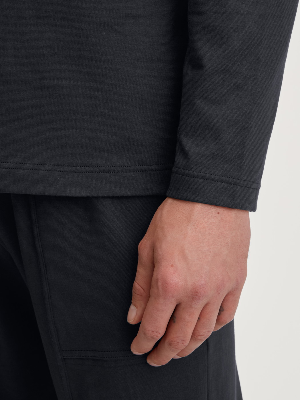 Men model is wearing Shirt long sleeve made of 100% Cotton in Black, Unicoloured from the RMX Sleep Leisure series by CALIDA, Detail