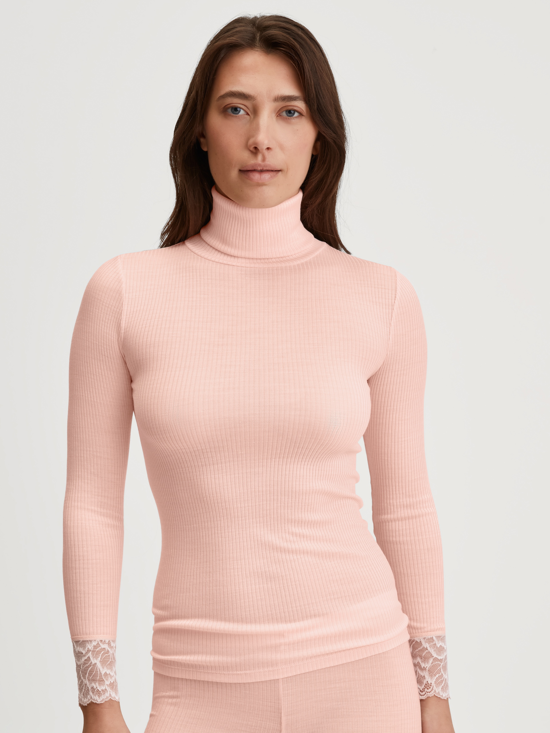 Women model is wearing Long-sleeve turtleneck shirt in wool-silk made of Wool in Pink, Lace from the Silky Wool Joy series by CALIDA, Front view